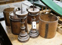 Six assorted treen measures and butter pails, a pair of pricket candlesticks, height 37cm and