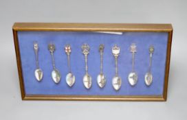 A collection of sixty four 800 standard silver (many gilt) and enamel souvenir spoons, early 20th