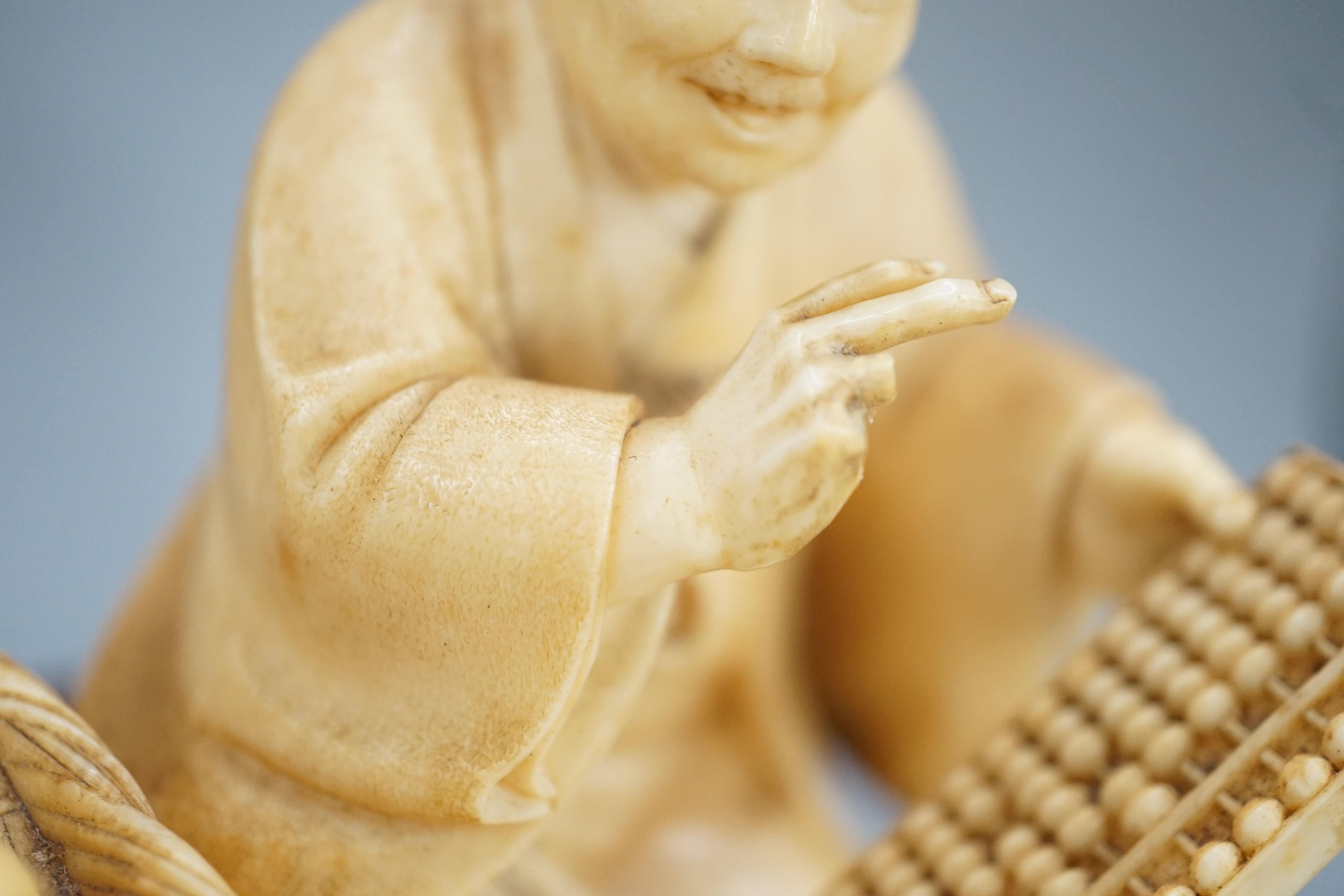 A Japanese ivory okimono of a street vendor kneeling and holding an abacus, Meiji period, 8cm, - Image 3 of 7