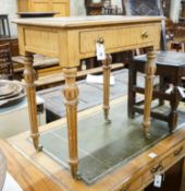 A Victorian golden oak side table, with single drawer, turned and fluted legs on brass castors,