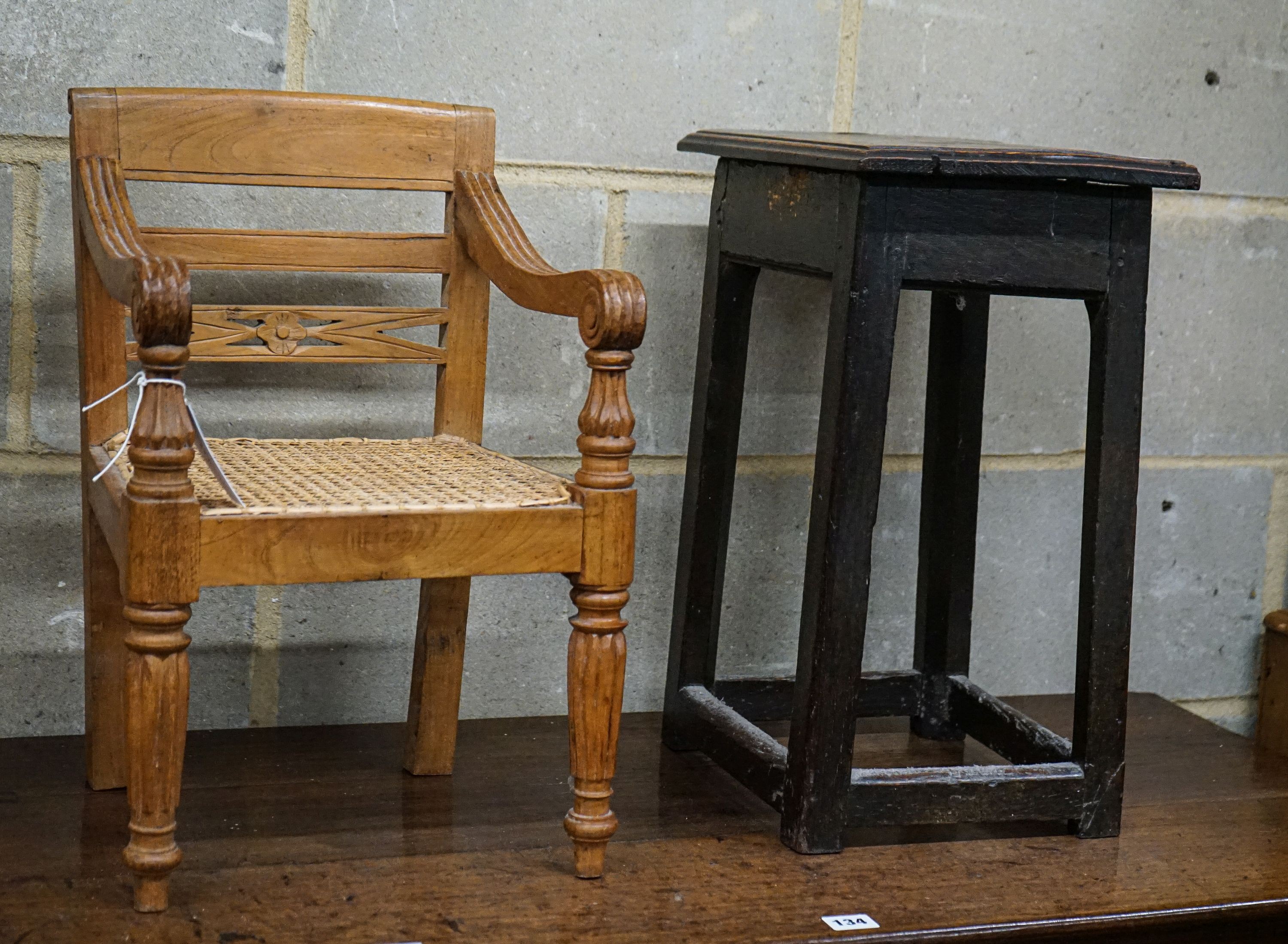 An 18th century primitive oak stool, width 34cm, depth 26cm, height 48cm and an Anglo Indian child's