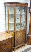 A Sheraton Revival mahogany display cabinet, crossbanded and inlaid, shape fronted, single glazed