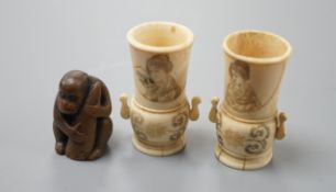 A pair of early 20th century Japanese miniature ivory vases, 5.3 cm, engraved with a lady and a wood