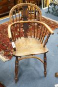 A 19th century yew and elm Windsor elbow chair with blind splat and crinoline stretcher, width 55cm,