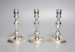 A modern set of three 18th century style cast silver candlesticks, J.B. Chatterley & Sons,