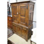 A 17th century style oak press cupboard, with three panelled doors, width 108cm, depth 50cm,