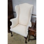 A George II red walnut wing armchair, with slender cabriole legs and pad feet, width 80cm, depth