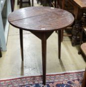 A George III oak cricket table, with circular top on tapered triangular legs, diameter 71cm height