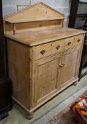 An early Victorian pine chiffonier, fitted two drawers and panelled doors on turned feet, width