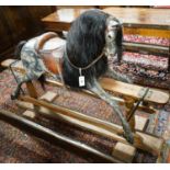 A large Edwardian Ayres type rocking horse on a turned safety frame, length 160cm, height 110cm