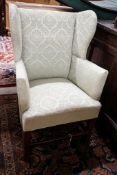 A George III oak child's upholstered wing armchair, width 52cm, depth 41cm, height 84cm