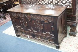 A William and Mary carved oak mule chest with K M initialled frieze and triple panelled front,