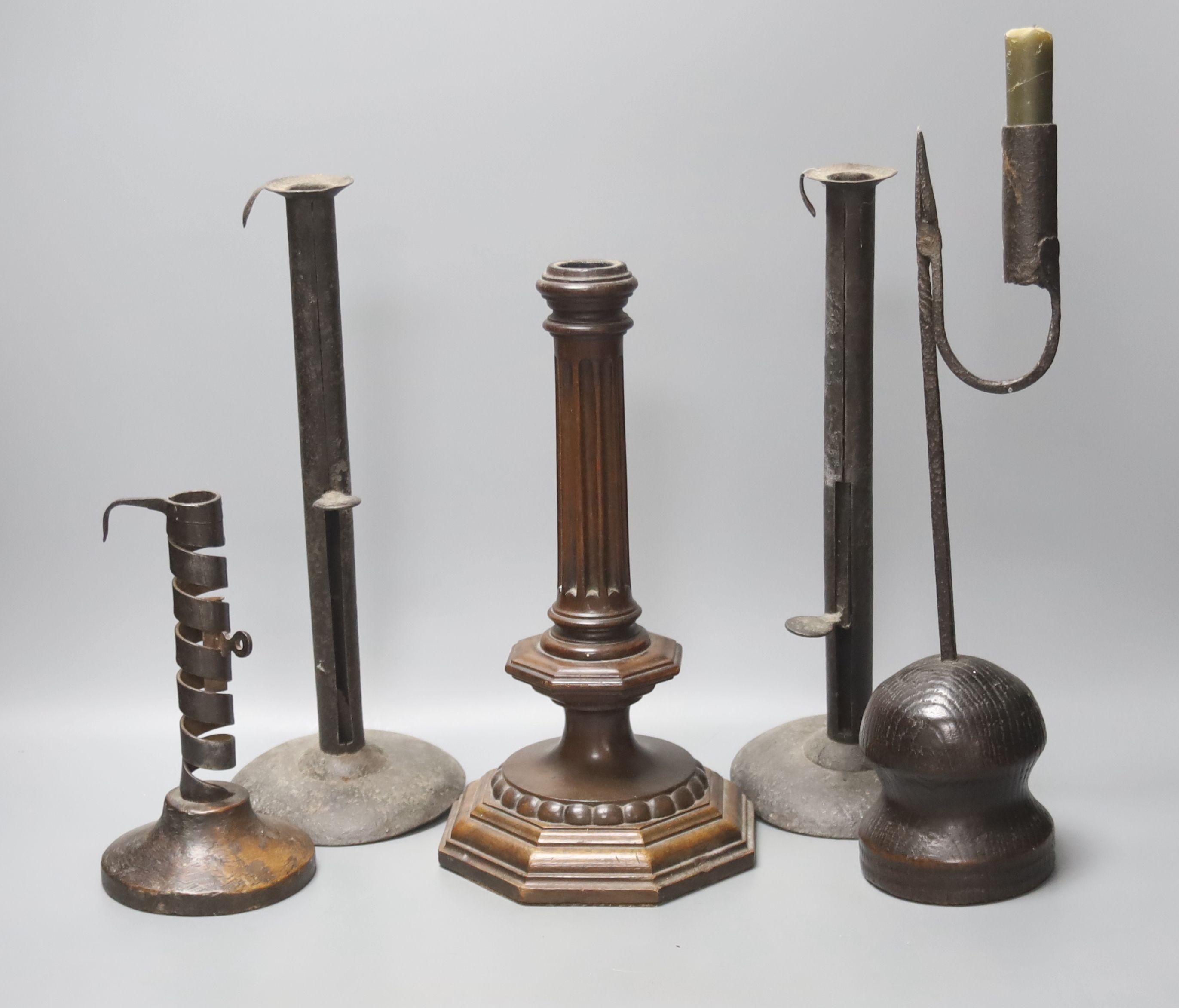 A wrought iron taperstick, a pair of iron telescopic candlesticks, a spiral candlestick, all