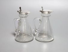 A pair of George V silver mounted glass whisky tot jugs, Hukin & Heath, Birmingham, 1925, 11.5cm.