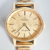 A lady's 1970's 9ct gold Omega manual wind wrist watch, on a 9ct gold bracelet, overall 18.5cm,gross