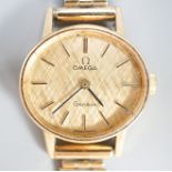 A lady's 1970's 9ct gold Omega manual wind wrist watch, on a 9ct gold bracelet, overall 18.5cm,gross