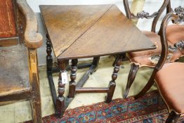 An early 18th century oak drop leaf table, with triangular flap and turned gateleg action