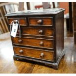 An antique mahogany miniature chest of drawers, width 27cm, depth 16cm, height 27cm