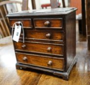 An antique mahogany miniature chest of drawers, width 27cm, depth 16cm, height 27cm