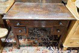 An early 19th century oak low boy, fitted three drawers, on square tapered legs, width 94cm, depth