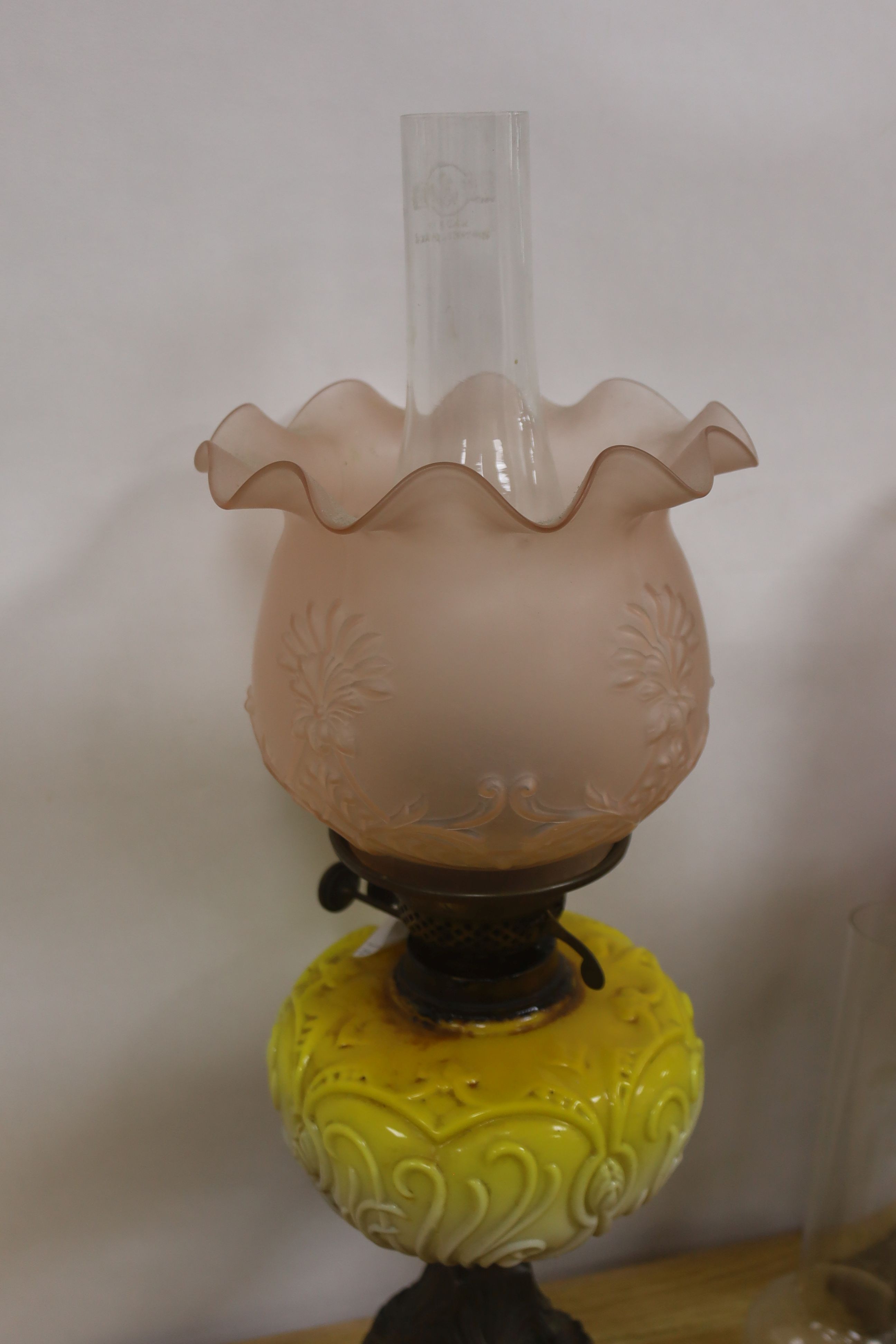 Two late Victorian brass mounted oil lamps with pink and yellow tinted glass reservoirs, tallest - Image 2 of 4