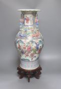 A large Chinese famille rose two handled vase, late 19th century, wood stand, restored 54cm incl