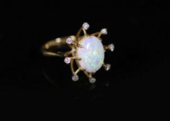 An 18ct gold, single stone oval white opal and eight stone diamond set modernist ring,size M,