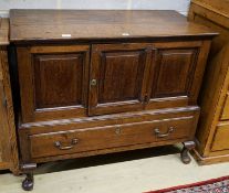 A mid 18th century oak mule chest, with later converted central door and later stand with cabriole