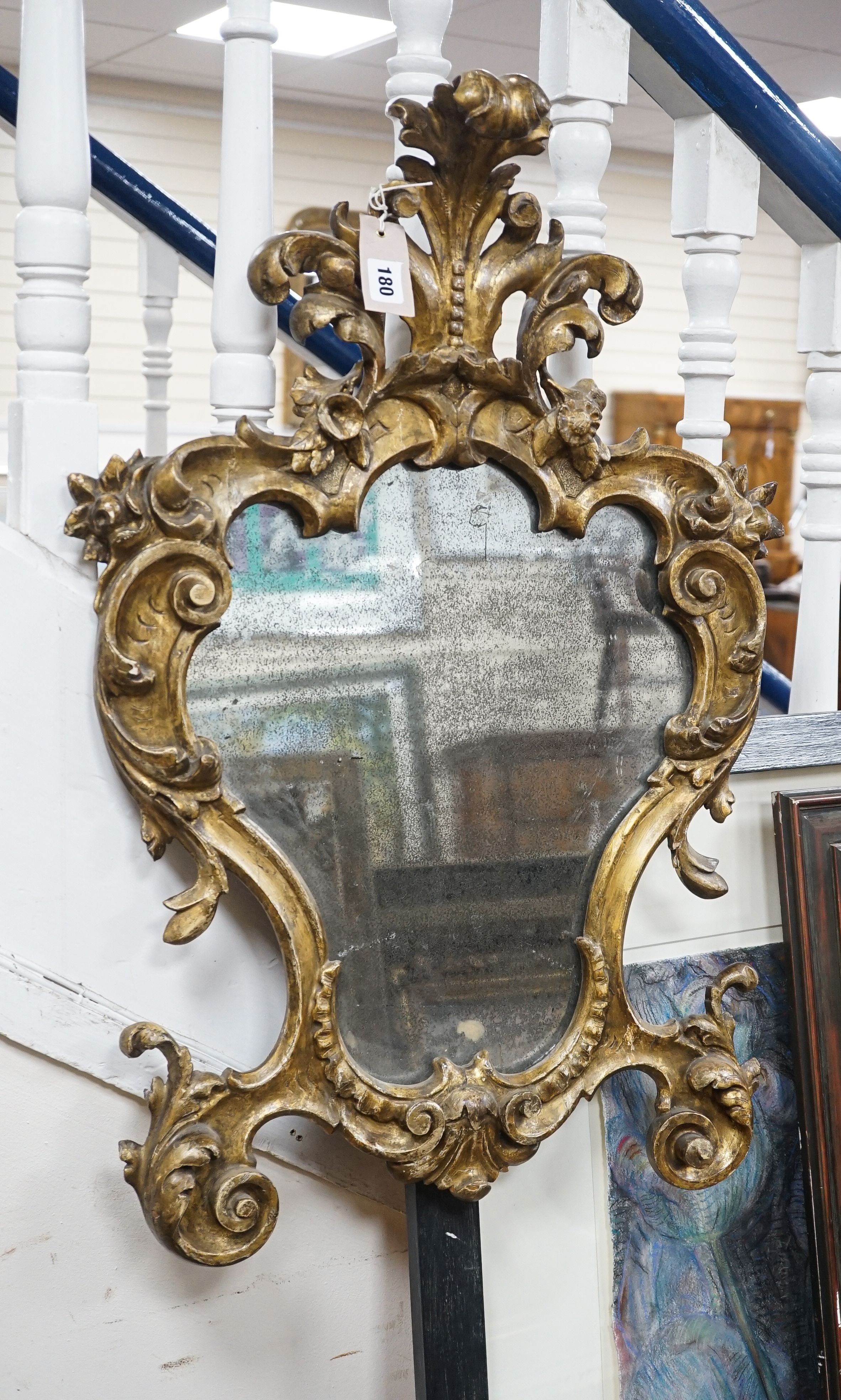 An 18th century Italian carved giltwood cartouche wall mirror, width 53cm, height 76cm