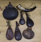 An early 19th century white metal mounted cow horn and six assorted powder flasks / costrels