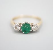 An 18ct and plat, emerald and diamond set three stone ring, size K, gross weight 2.3 grams.