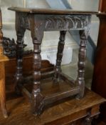 A 17th century style oak joint stool, with foliate carved frieze and turned legs, width 44cm,