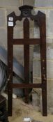 A late Victorian oak easel, with floral carved decoration, width 33cm, height 117cm