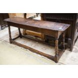 A 17th century style oak long stool, with solid seat on turned legs, length 119cm, depth 28cm,