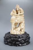 A Japanese ivory okimono of a samurai on horseback, with an attendant behind him, signed, late