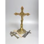 A group of four brass and metal crucifixes, largest 34cm