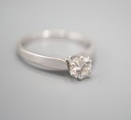 A modern white metal and solitaire diamond ring, size M, gross weight 2.3 grams.