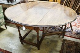 A 17th century style oak gateleg table, with oval top and two frieze drawers, open to 170cm, width