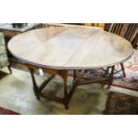 A 17th century style oak gateleg table, with oval top and two frieze drawers, open to 170cm, width