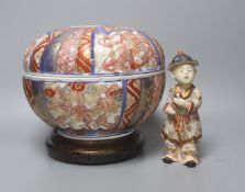 A 19th century Japanese Imari box and cover and a Satsuma pottery figure of a boy holding a Daruma