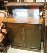 A small Victorian rosewood chiffonier with raised mirror back, 3/4 gallery over a pair of plain