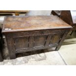 A 17th century oak coffer, with later carved front, length 120cm, depth 56cm, height 69cm