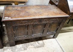 A 17th century oak coffer, with later carved front, length 120cm, depth 56cm, height 69cm