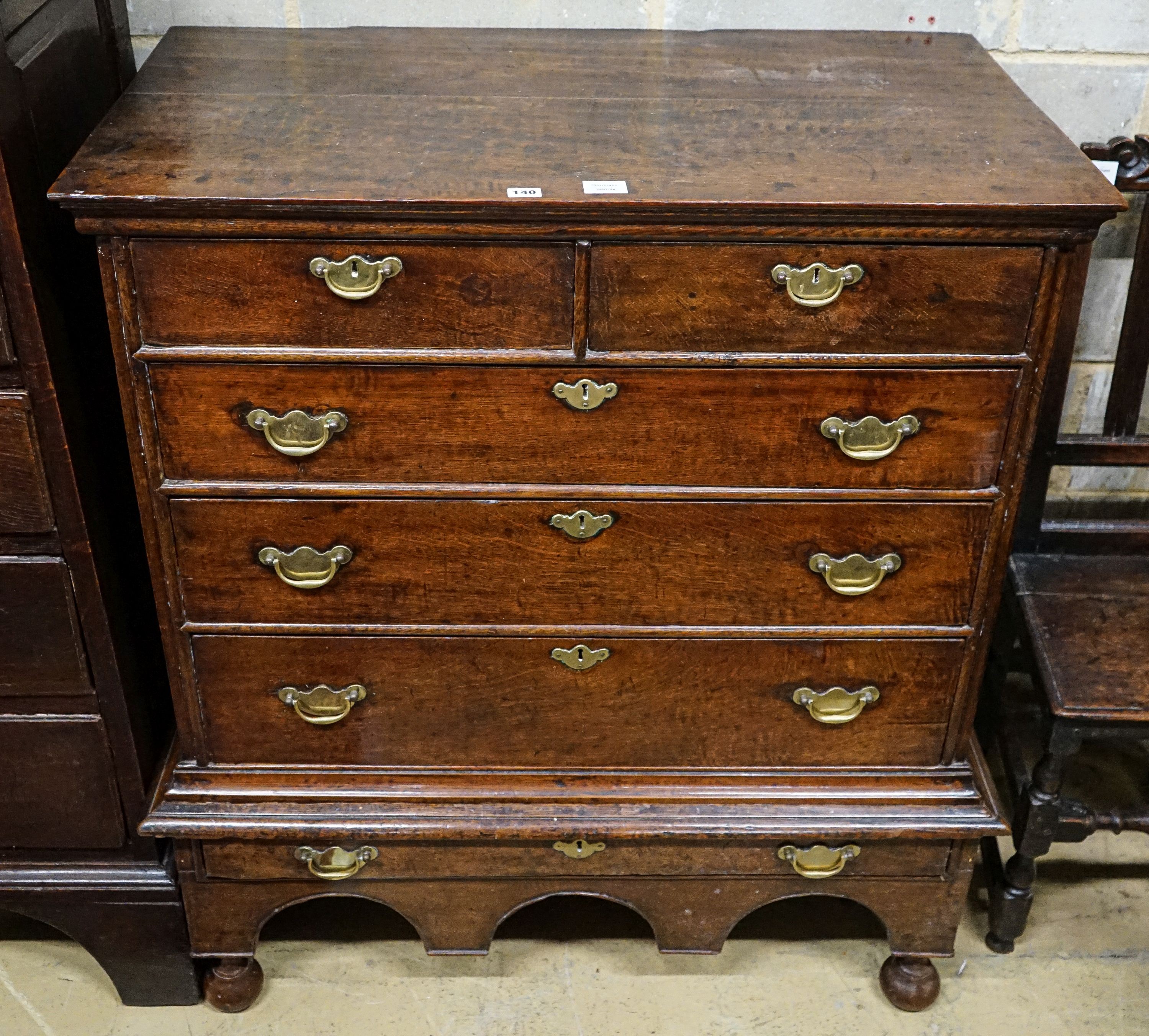 An early 18th century oak chest on stand, fitted two short and four long drawers, width 106cm, depth