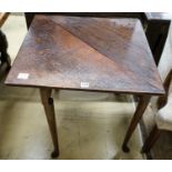 A George II oak folding top tea table, with triangular flap, on turned legs and pad feet, 64cm