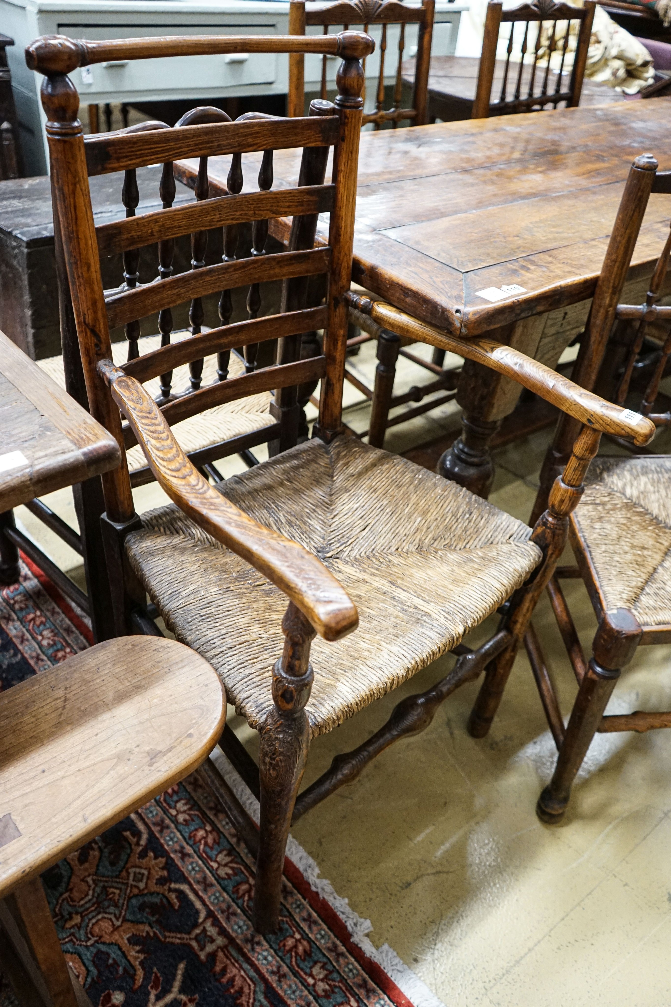 A harlequin set of five oak, elm and beech spindle back chairs, with rush seats and a similar - Image 2 of 4