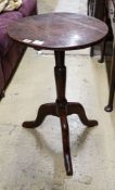 A George III oak tripod table, with circular top and slender baluster stem, diameter 46cm height