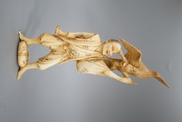 A Japanese ivory okimono of a man holding a monkey which is being attacked by an eagle, early 20th