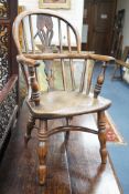 A 19th century Midlands area yew and elm Windsor child's elbow chair with crinoline stretcher, width