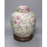 A Chinese thousand flower famille rose jar and cover, early 20th century, wood stand 28cm